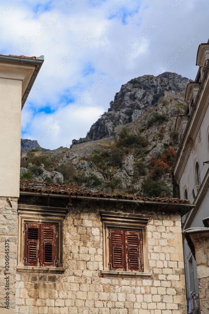 Poster Shutters on Old Stone Wall