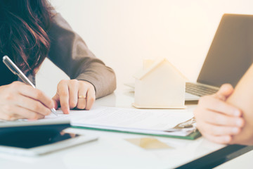 Client Signs Document to Buy House and Real Estate