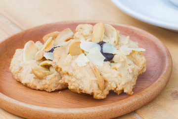 extreme close up cashew cookies on wooden dish with blurred background