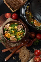 Roast in a clay pot rustic style view from above