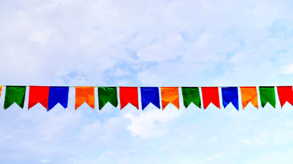 coloured small flags on background sky / photography with scene coloured small flags on background sky