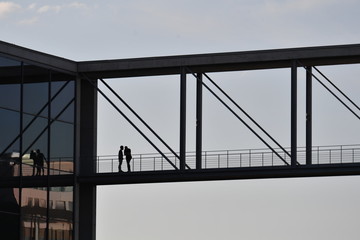 Two men are talking on a bridge in Berlin's government district