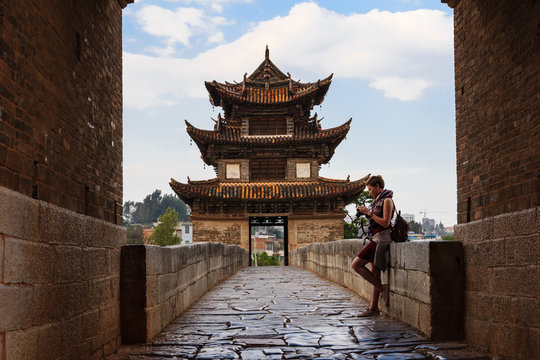Tourist female standing on ancient Chinese bridge