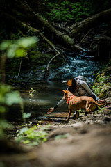 girl and dog by stream - 206555563