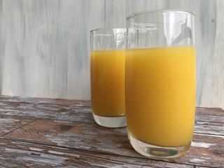 low angle shot of two glasses of orange juice
