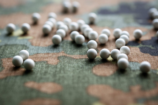 airsoft balls on the background of camouflage fabric