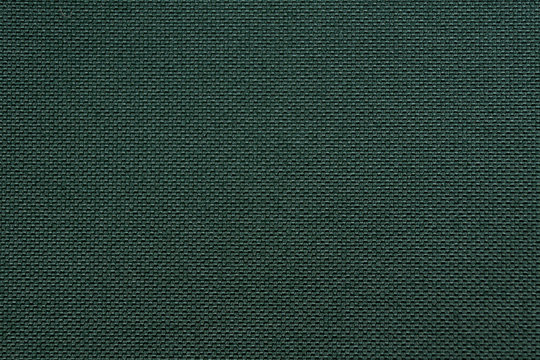 texture of dense dark green fabric closeup