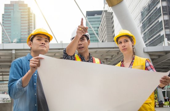 Team of Young Females and Male Engineers Working on Building projects