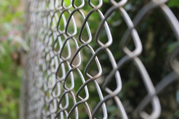 close up and blurry selective focus of monochrome photo of stainless steel  net door . reflective surface