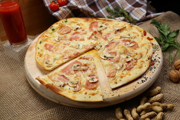 Pizza thin with a glass of juice