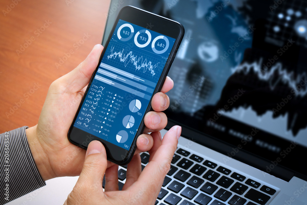 Poster Investor analyzing stock market report and financial dashboard with business intelligence (BI), with key performance indicators (KPI).Businessman using smart phone with laptop computer.