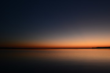 Twilight sky over the lake in the beautiful colors of the sunset afterglow