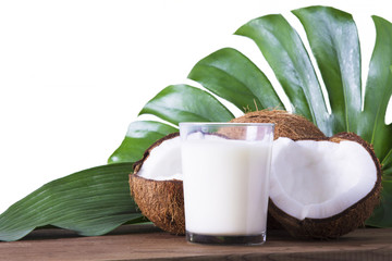 coconuts and glass of coconut milk with wooden background