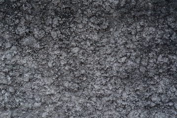 Black cracked cement texture background.