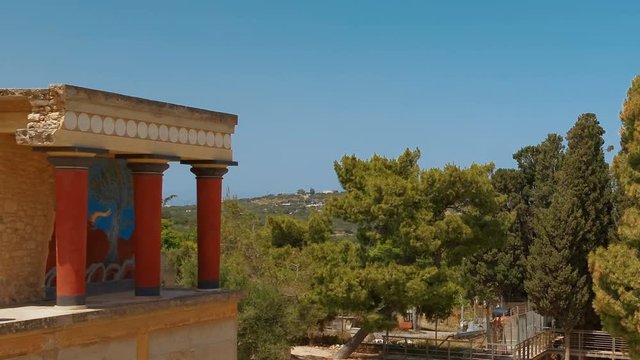 The north entrance to the Minoan Palace of Knossos in Heraklion, Crete, Greece with the charging bull fresco. Knossos is the largest Bronze Age archaeological site in Crete and Europe's oldest city.