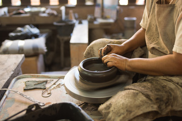 Fototapeta na wymiar potter's hands shaping soft clay to make an earthen pot