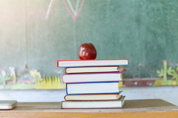 Textbooks and apple on a desk,education concept.