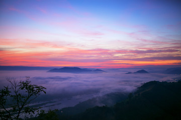 Fototapeta na wymiar Landscape twilight mist at the dawn of a high mountain pass to the Mekong river the between Thai - Laos.