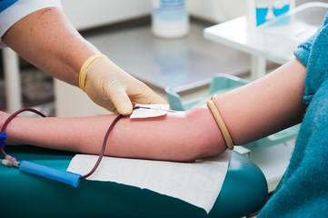 Blood donor at donation with a bouncy ball holding in hand