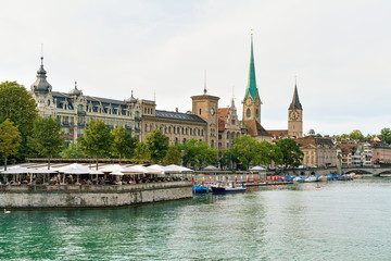 Restaurant terrace at Limmat quay and Saint Peter Fraumunster
