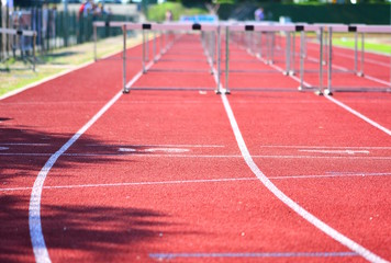 A hurdle race on red running in stadium track; success concept. - 206570510