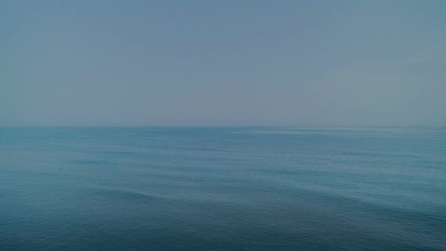 Aerial drone shot of calm and clear tranquil waters of sea or ocean, beautiful and serene landscape, image of endless horizon. concept meditation, yoga and peace