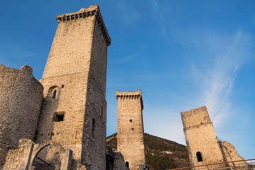 Towers and rampart of Pacentro castle at sunset (Italy)
