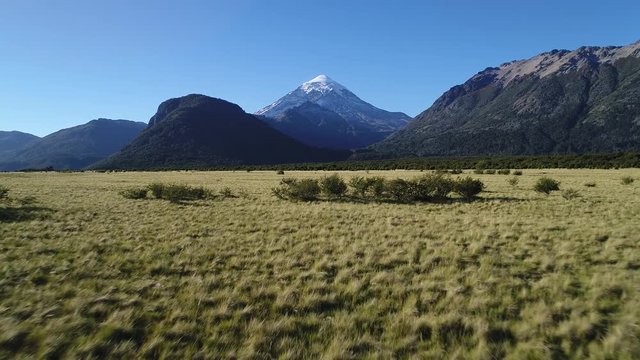 Aerial  drone Scene of Lanin Volcano, National Park Lanin, Neuquen, Patagonia, Argentina, sunny day in summer. Camera moving forward from ateppe to lanin volcano