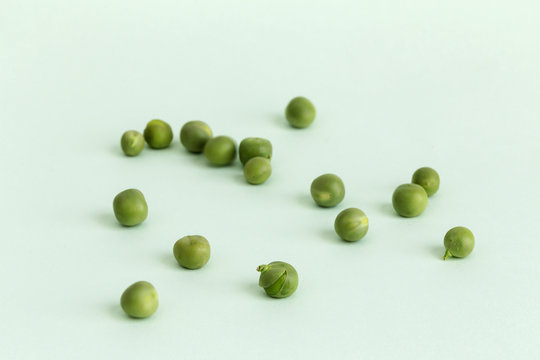 Fresh peas on green background.