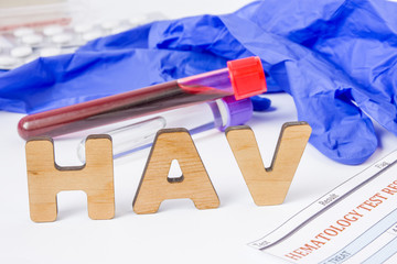 HAV Medical acronym or abbreviation of hepatitis A virus in laboratory test diagnostics and physical diagnosis. Word HAV is near blood sample in lab tube, protection glove, blood test and medications 