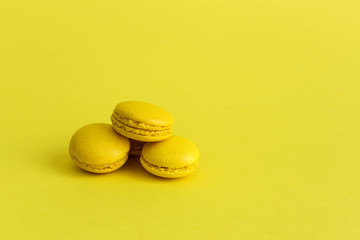 Delicious macaron with yellow background