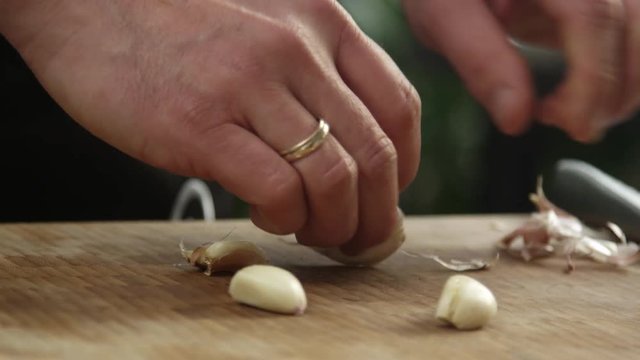 Chef peeling garlic