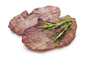 Grilled beef steaks with spices isolated on white background.