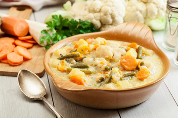 Vegetable soup with ingredients carrot, cauliflower, potato and