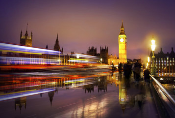 Big Ben, hoses of Parliament at night. View from the Westminster bridge. Traffic lights and walking...