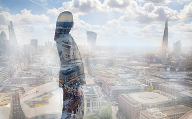 Young woman looking at the City of London, financial district. Early morning. Sun rise. Future, planning and business progress concept. - obrazy, fototapety, plakaty