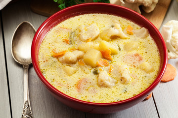 Vegetable soup with ingredients carrot, cauliflower, potato and parsley