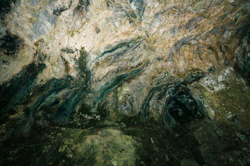 Beautiful cave. View from inside dark dungeon. Textured walls of cave. Background image of underground. Dampness inside cave.