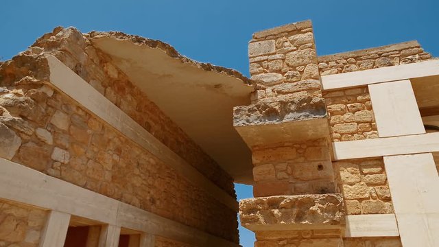 Tracking shot of restored ruins within the complex of the Minoan Palace of Knossos, Heraklion, Crete, Greece. Knossos is the largest Bronze Age archaeological site in Crete and Europe's oldest city.