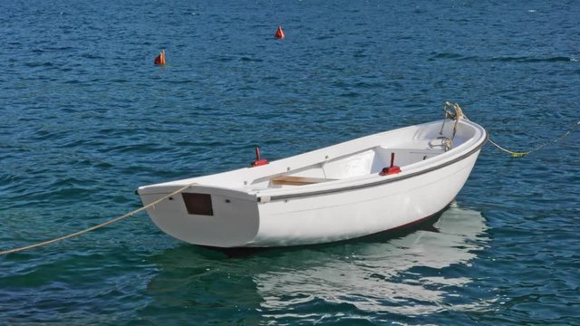 White boat on blue waves