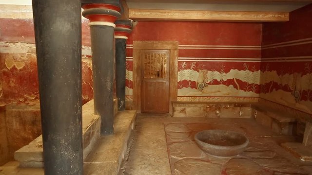 The Throne Room in the Minoan Palace of Knossos, Heraklion, Crete, Greece flanked by a beautiful Griffin couchant fresco.
