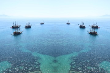 Ships floating on the sea in the distance.