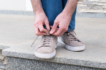 Men's hands tying laces ready for walking