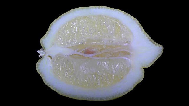 Cut Yellow Lemon - Macro Close up View on a Black Background