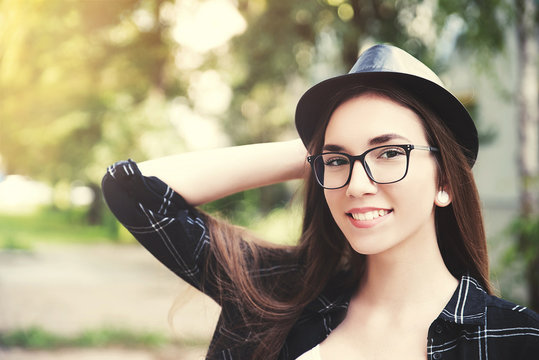 Young hipster woman wearing hat and glasses outdoor