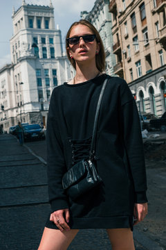 Stylish and fashionable girl with glasses on the city street