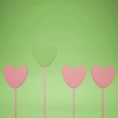 Fototapeta na wymiar Minimal love and care concept idea, pink and green heart shape candies on pastel background with copy space