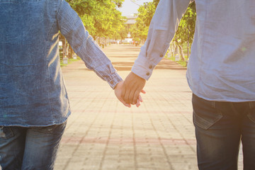 Man and woman holding hands of romantic couple in love