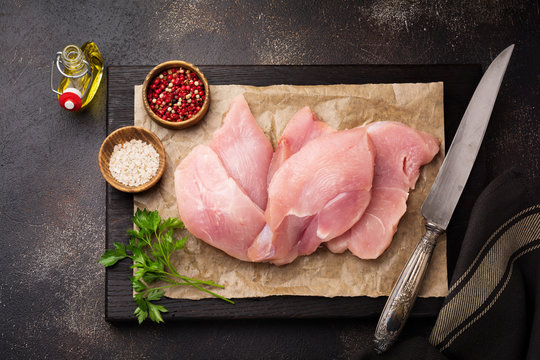 Raw Meat Of Turkey Steak On Dark Old Background. Top View.