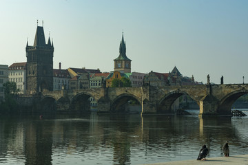 Fototapeta na wymiar Prague, view of the Charles Bridge and the old tower by the river in the evening